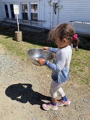 carefully carrying her bowl of water