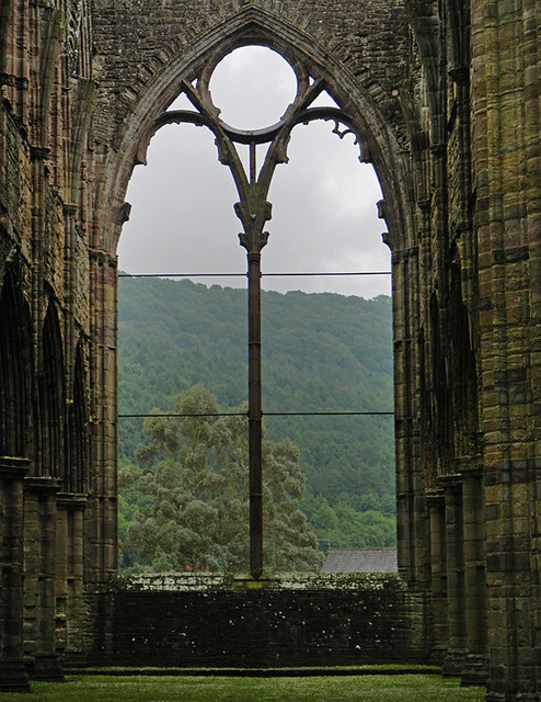 View through an arched window at the ruins at Tintern Abbey in Wales