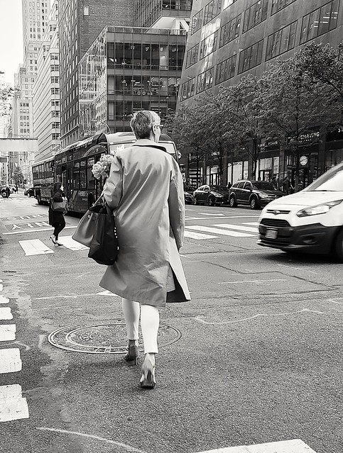 Woman walks down Fifth Ave., NYC