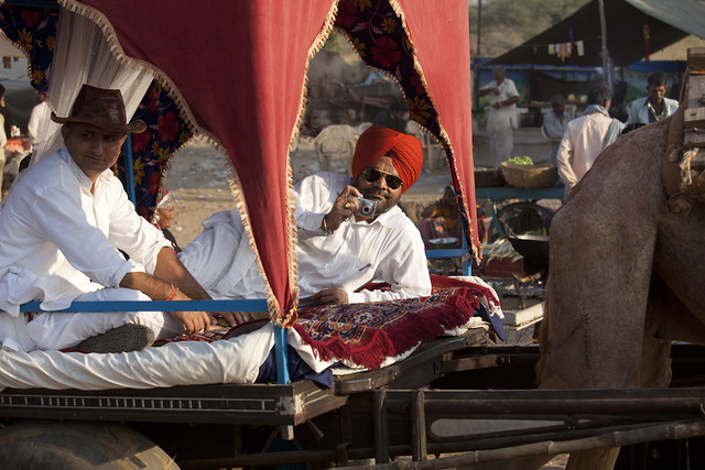 A tourist at the Pushkar Camel Fair , Rajasthan , India