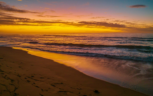 Aerial sunrise seascape with high cloud by Merrillie, Sunrise seascape with clouds at Shelly Beach on the Central Coast, NSW, Australia.landscape shellybe