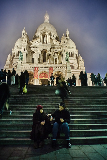 Couple drinking wine in front of the Montmartre's Basilica of the Sacré Cœur by night, Paris