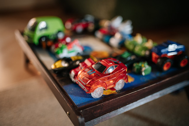 Toy cars parked neatly on a small folding table