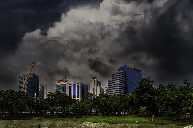 Clouds over buildings surrounding the Benchasiri Park, Bangkok, Thailand.  635-Edit-Edita