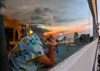 Amalie on her phone while the sun sets