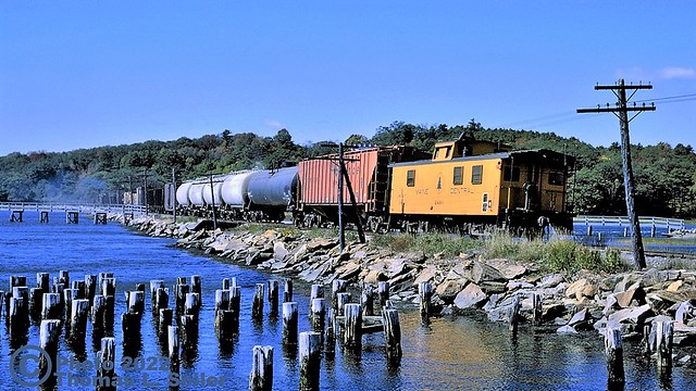 MAINE CENTRAL TRAIN #324 ROLLS WEST WITH ONE OF MEC'S CADILLAC STYLE CABOOSES ON THE REAR - WISCASSET, MAINE - SEPTEMBER 30, 1981