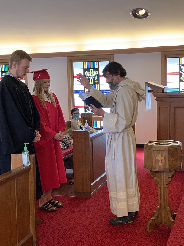 Brad blesses grads Wyatt Imhoff and Rayven Jacobson.