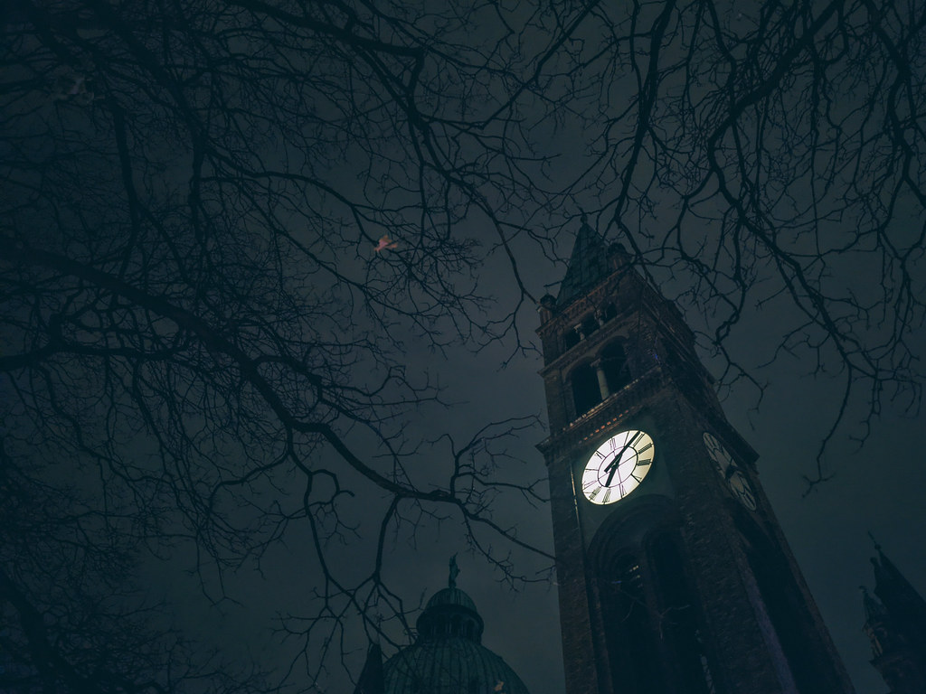 Illuminated clock on the bell tower of St. Anthony of Padua Church in Vienna at night