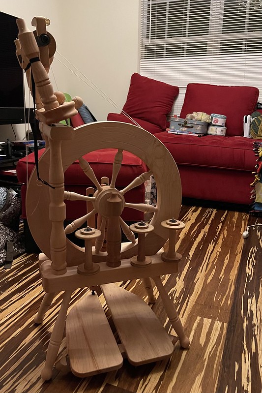 a fully assembled Ashford Traveller spinning wheel with 3 empty bobbins on the built-in lazy kate