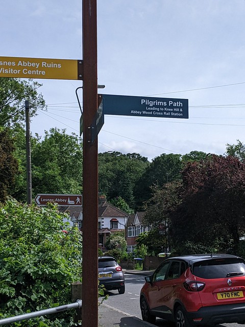 Fingerpost near Abbey Wood. What is the station cross about?