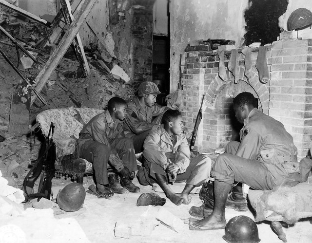 SC 364370 - In a bomb shattered house members of the 92nd Inf. Div. are drying out. 14 December, 1944.