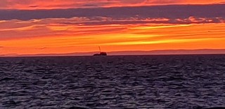 Bike ride sunset looking out to sea at Pensarn promenade with tug SEA BRAVO in shot 29 May 2022