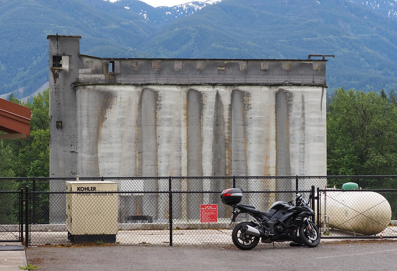With Old Superior Portland Cement Silos: Went all the way up the hill because I couldn't find a good place to stick the bike closer to the highway for a shot with the silos.