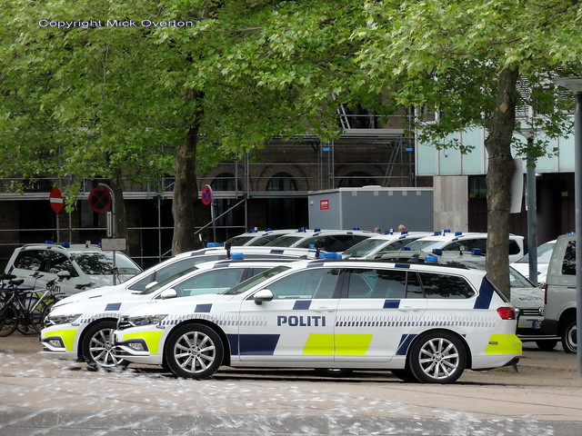 Ten Copenhagen Police traffic payrol cars are seen behind a fountain