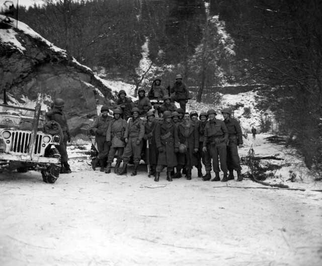 SC 335401 - Two patrols, one from the 84th Infantry Division, First U.S. Army, and the other from the 11th Armored Division, Third U.S. Army, meet at a prearranged rendezvous on the Liourthe river closing the Bulge in Belgium.