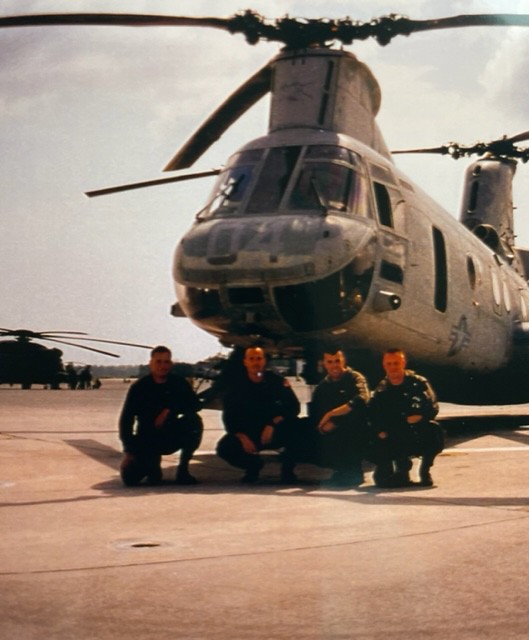 Soldiers in front of a U.S. Marines helicopter