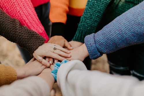 Diverse hands in a circle (How To Build Self-Confidence)