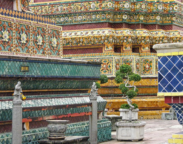 colourful mosaic tiles in a three-dimensional floral pattern that adorns the exterior of the Wat Pho Pagoda, part of the Royal Palace in Bangkok, Thailand
