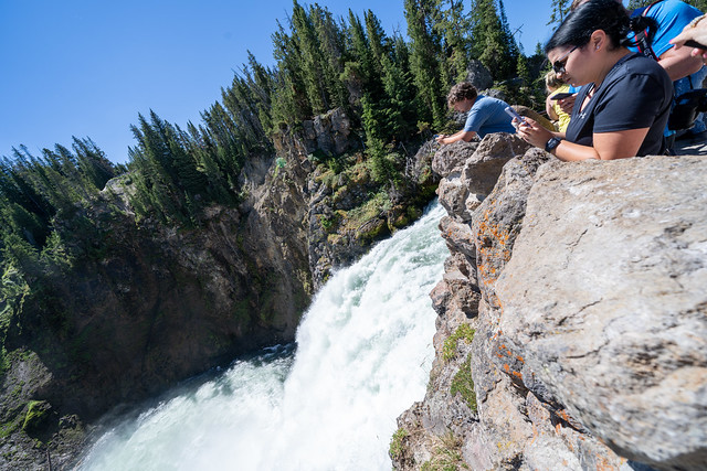 Wyoming, USA - June 29, 2021: Crowds of tourists view the brink of the upper falls in the Grand Canyon of the Yellowstone National Park