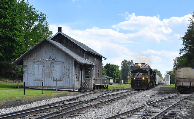 NS grain train passing the depot at Pleasant Lake
