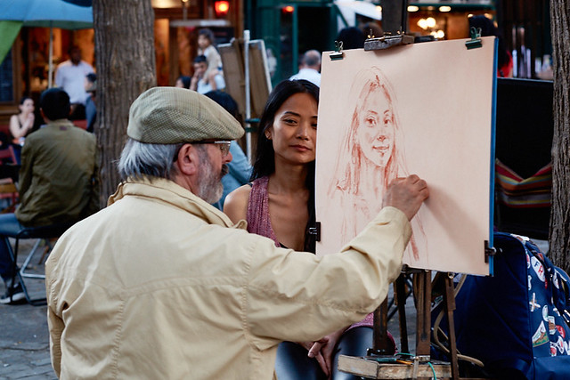 Painter of Montmartre drawing portrait at Place du Tertre, Paris, France