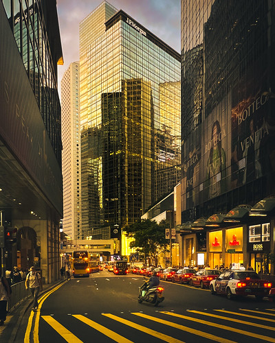 glasswall reflection taxi motorcycle buildings building sunset life hklife iphoneography street hltam mobilephone iphone streetphotography hongkong photodocumentary hongkonglife city