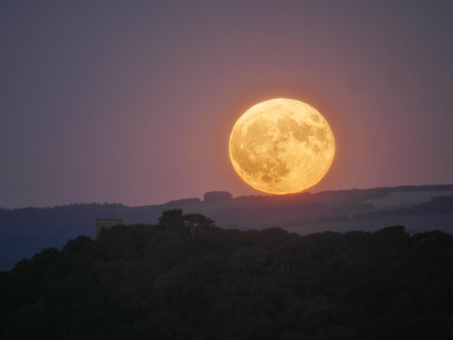 Strawberry full moon rising over Conygar Tower