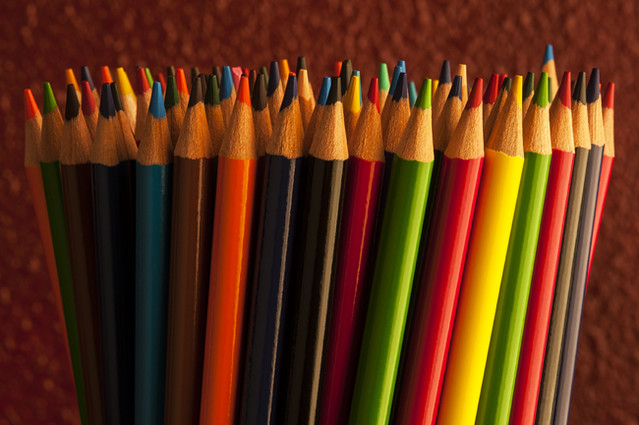 Close-up of multicolored pencils with design elements in rows