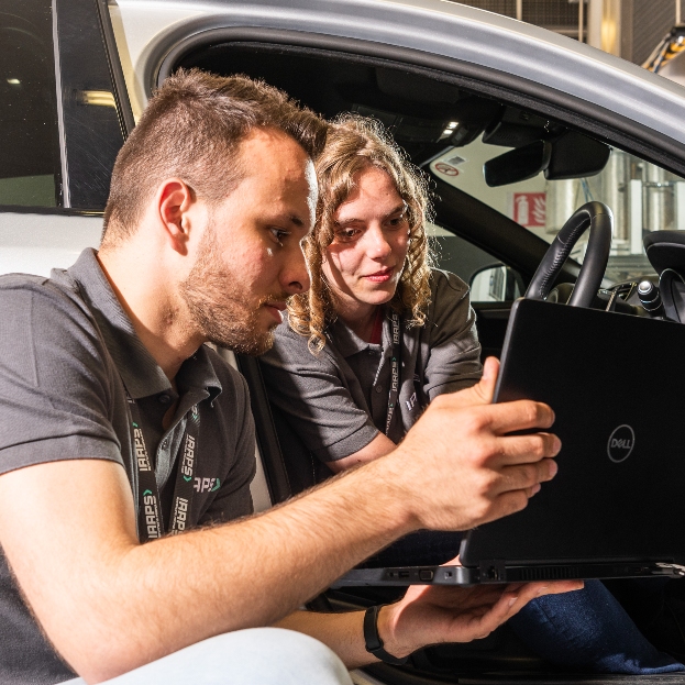 Two IAAPS researchers look at results of an experiment on a laptop