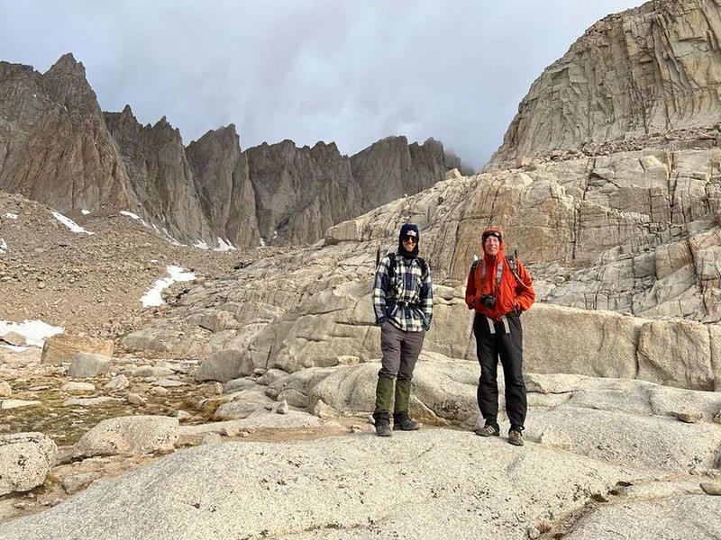 My son and I at Trail Camp with Mount Whitney in the far distance enshrouded by blowing clouds
