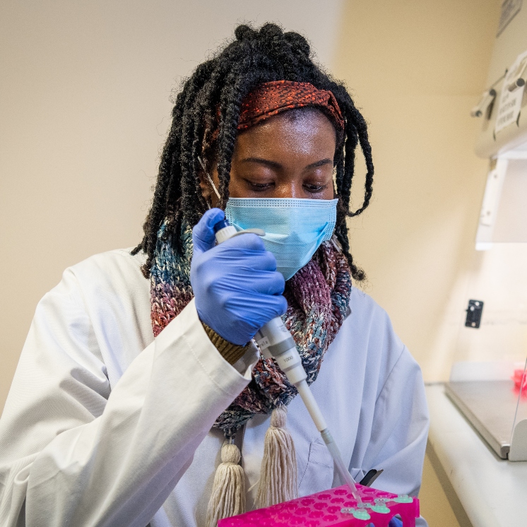 Masked researcher in a lab