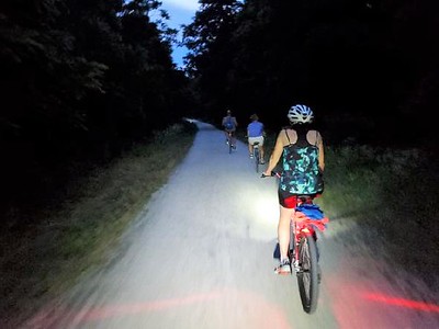 photo of nighttime bike ride along trail