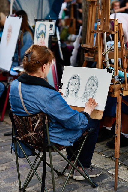 Painter of Montmartre drawing a portrait at Place du Tertre, Paris, France