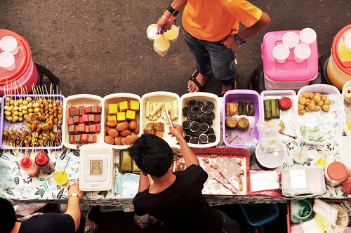 Filipino chef vendor cooking local street food philippine style at intramuros square of Maynila in Manila, Philippines. From Heading to the Philippines? Our 10 Best Travel Tips