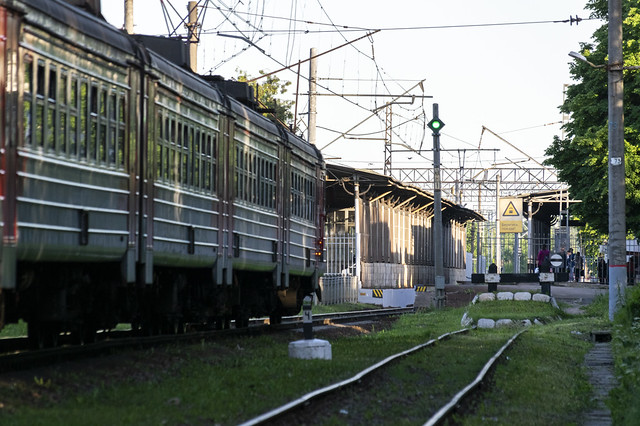 the #ПН1 repeater of exit traffic lights is green - the ЭД4М-0420 commuter electric trainset arriving on a Tsarskoye Selo station in St Petersburg suburbs can departure