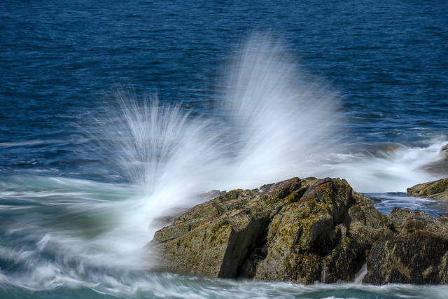 Wave crashing onto a large rock near Otter Point, Acadia National Park, Maine