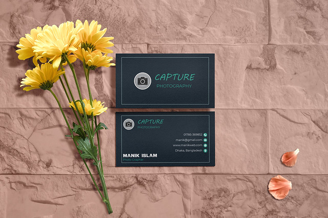 Clean minimal business card mockup on split face stone with flowers