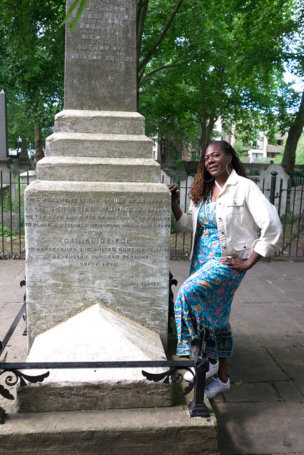 DSC_4663 Marilyn from Philadelphia at Bunhill Fields Dissident Cemetery London City Road with the Memorial for Daniel Defoe who wrote Robinson Crusoe.