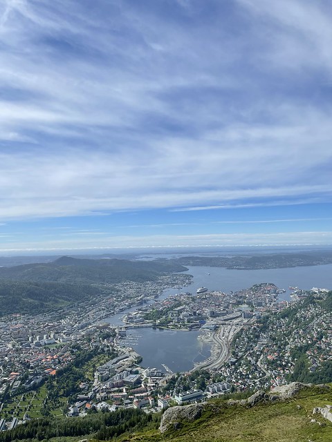 View from high above the city of Bergen, showing it surrounding the water. 