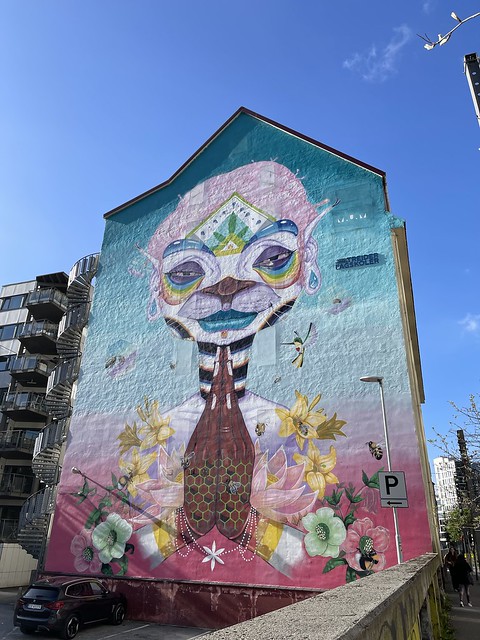 A large mural covers the side of a multi-story building.
