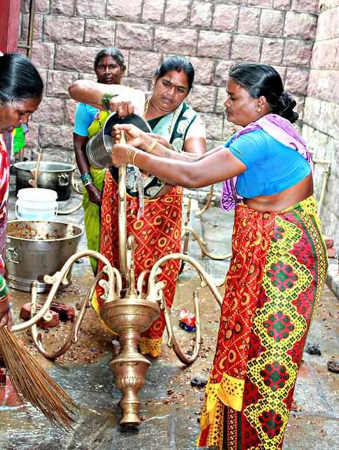 Women cleaning the temple oil lamps for the Bonaalu Festival, Sri Peddamma Thalli Temple