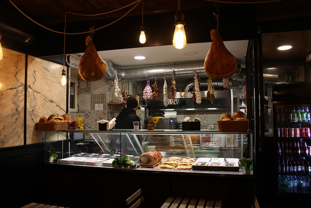Prosciutto hanging in a shop