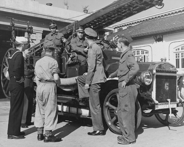 British and American service personnel talk with the Hong Kong Fire Brigade The engine is an ancient Dennis. 29 January 1946