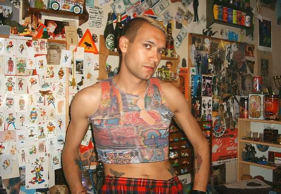 Self Portrait in front of my Joker collection in the kitchen wearing kilt and graffiti-top Vintage Danny Hennesy photo pic image