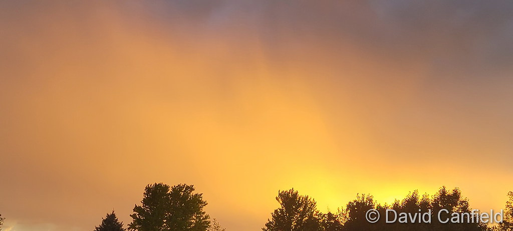 Independence Day sunset casts evening storm clouds in orange. (David Canfield)