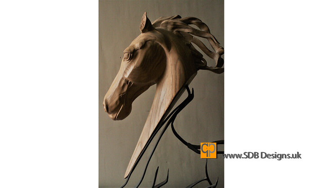 A carved horses head sculpture with metal running base body by SDB Designs carved by Sean Broadbent