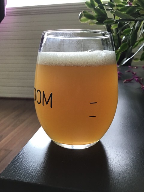 Wet Coast's 7th Anniversary hazy IPA in glass on table. 