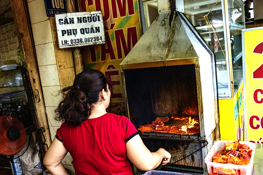 Woman grilling pork chops at 6-27AM on 7-12-22--Vung Tau copy