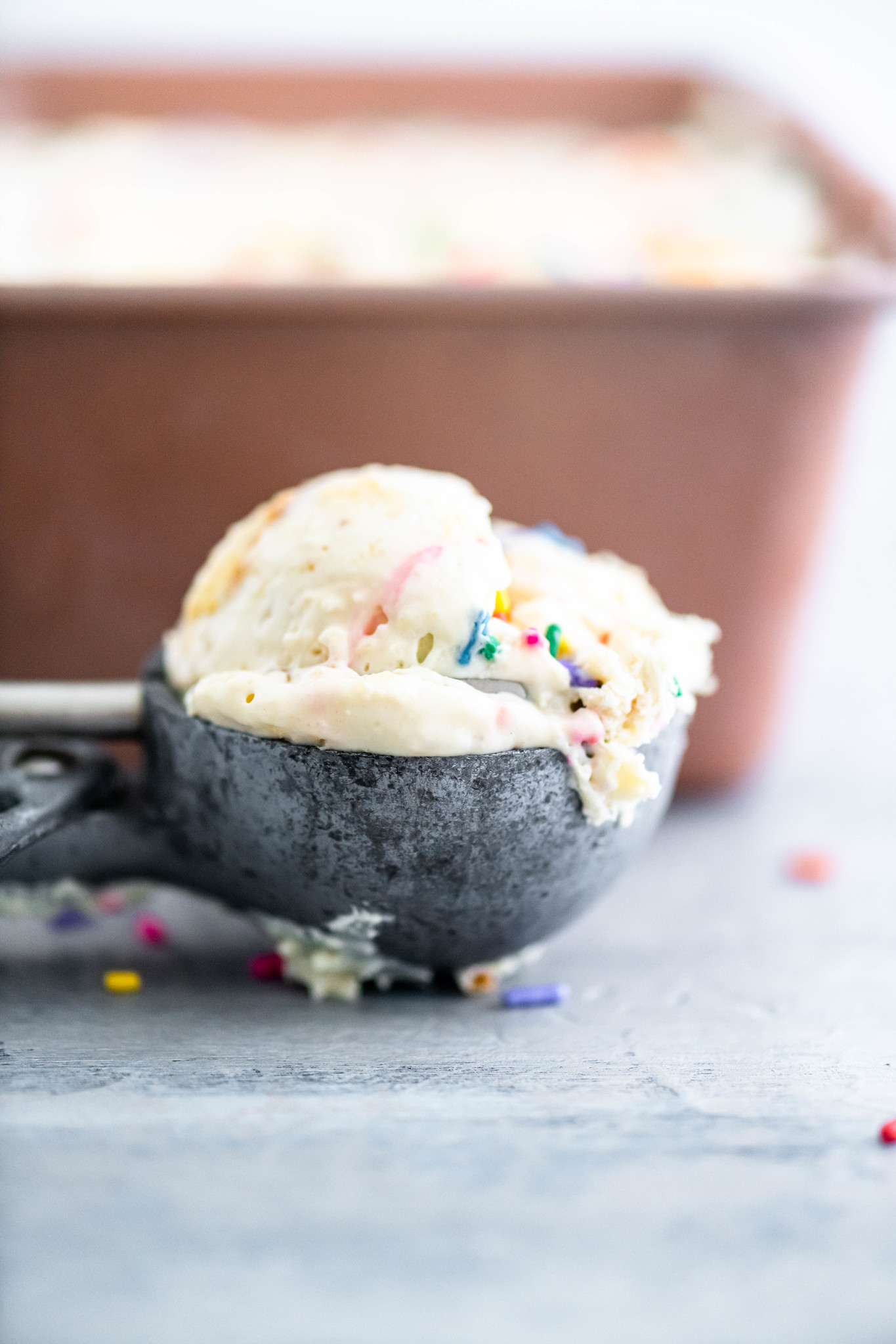 Scoop of cake batter ice cream in an old fashioned ice cream scoop.