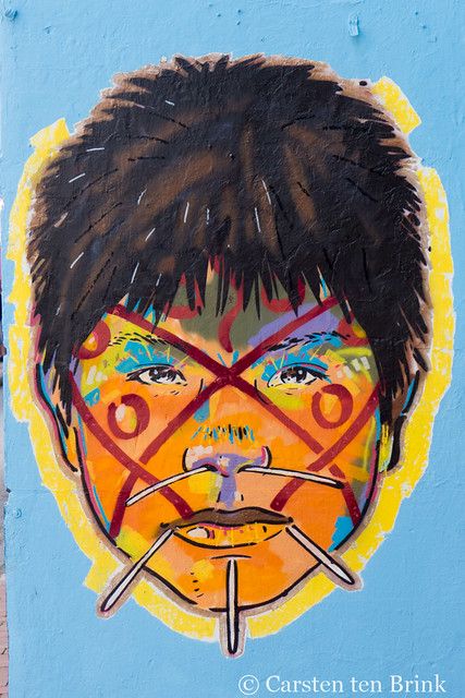 Bogota street art - indigenous boy with tattoos and piercings